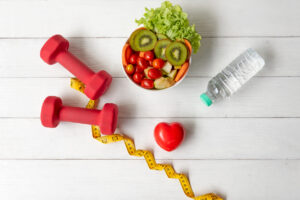 Diet Healthy food and lifestyle health concept. Sport exercise equipment workout and gym background with nutrition detox salad for fitness style. Health care Concept