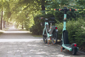 Bike Share and Scooter Sharing System in Green City Street. Electric Bicycle, e Scooter for Rental Service in Europe. Modern Eco Vehicle.