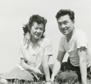 Young Asian Couple Sitting in the Grass