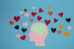 pink paper head and blue brain in it, around many colorful hearts, man in love and love of the air, head as copy space, flat design, human composition in love
